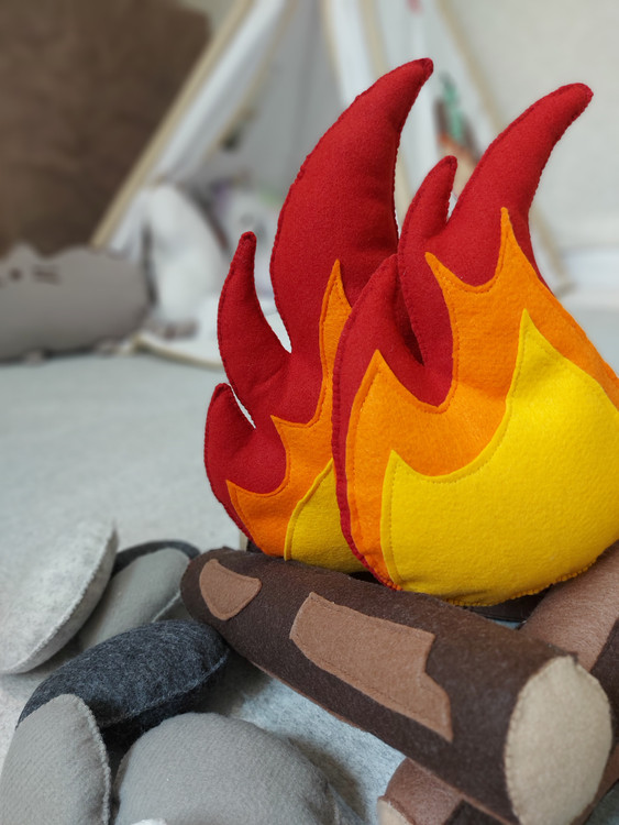 Fabric campfire set with plush stones next to kids teepee